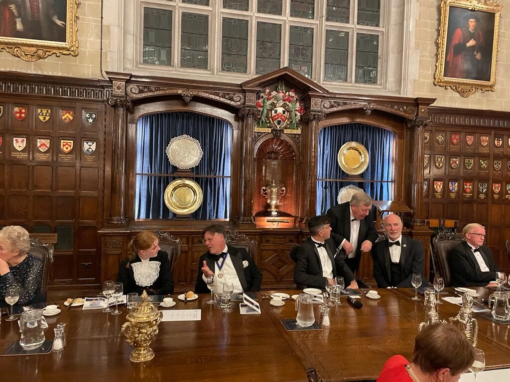 The top table during speeches, with the magnificent carved screen behind
